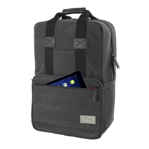 Close up view of the front of the Hex Supply Convertible Backpack, charcoal, showing the accessory item zipper partially undone with a tablet partway out of the compartment