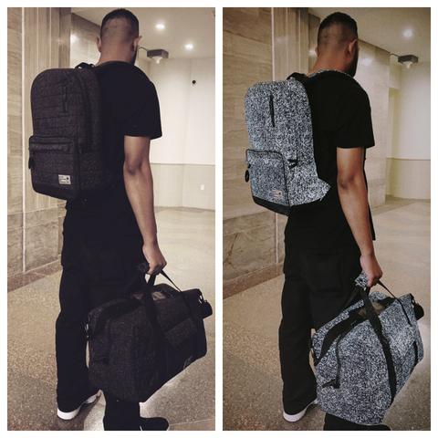 HEX Galaxy Signal backpack in black reflective lifestyle view showing bags with and without light source