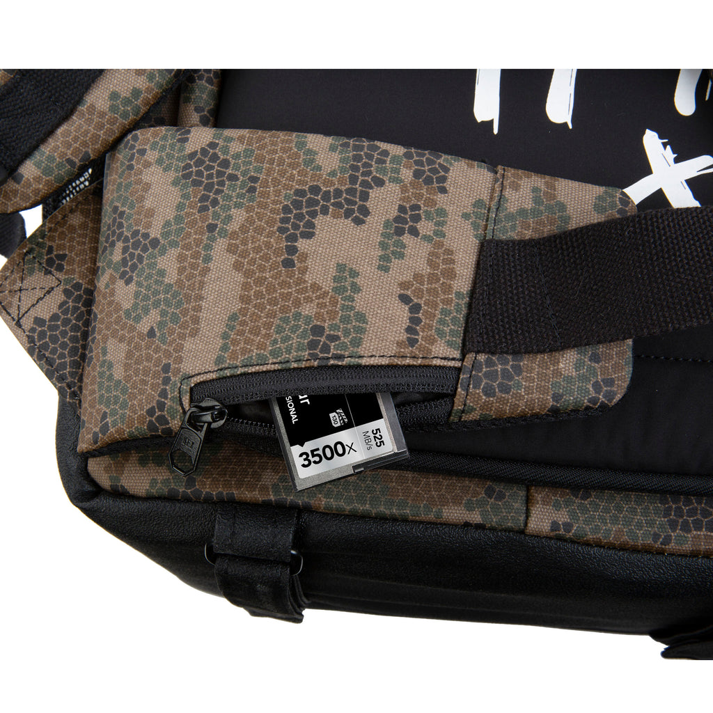 Close up of HEX x Rory Kramer Cinema Backpack, showing Micro SD card partially extending from waist belt pocket