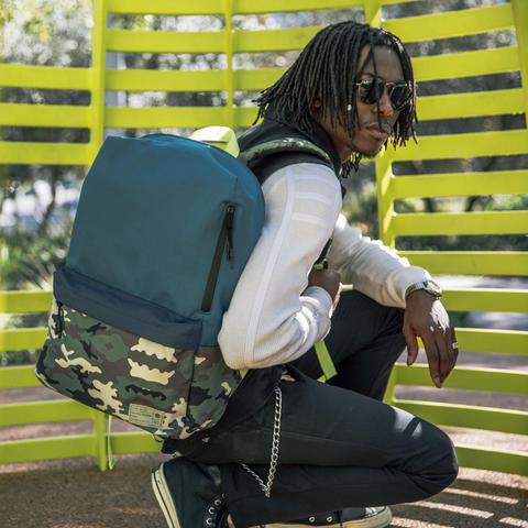Man wearing HEX Aspect Exile Camo/Blue Backpack