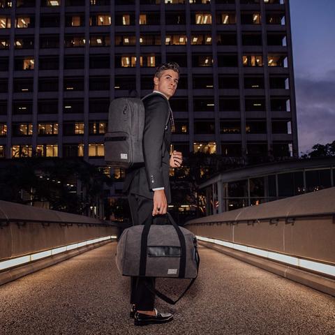 Man carrying gray HEX Supply Signal Backpack