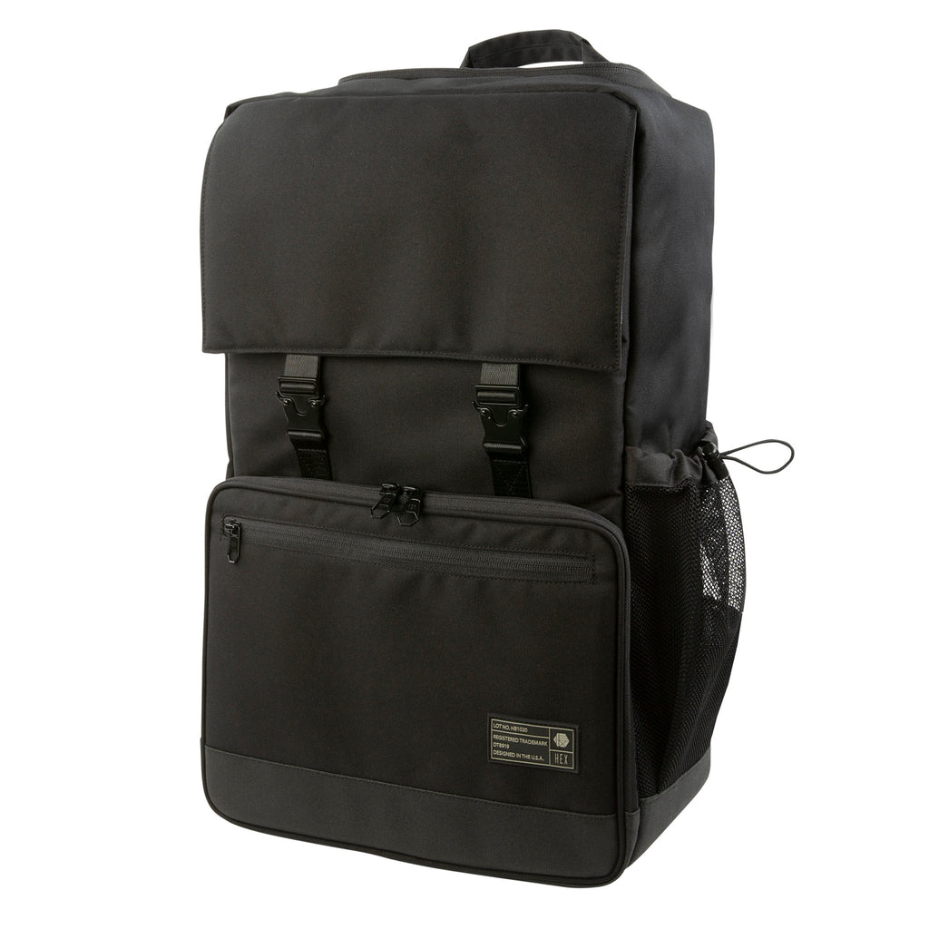 Front view of the Hex Black Cinema Backpack, black and gray, showing the large zippered accessory pocket and main compartment buckles, fully closed
