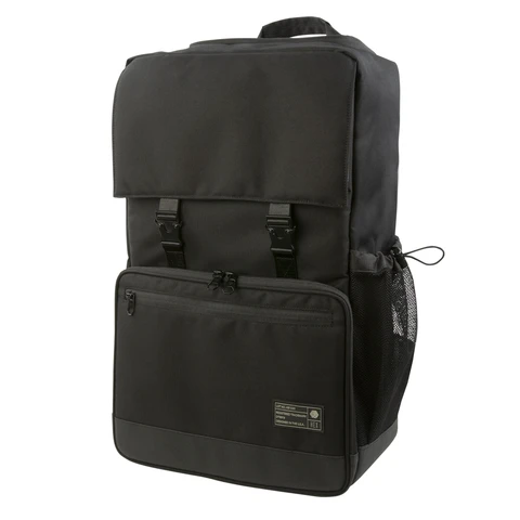 Front view of the Hex Black Cinema Backpack, black and gray, showing the large zippered accessory pocket and main compartment buckles, fully closed
