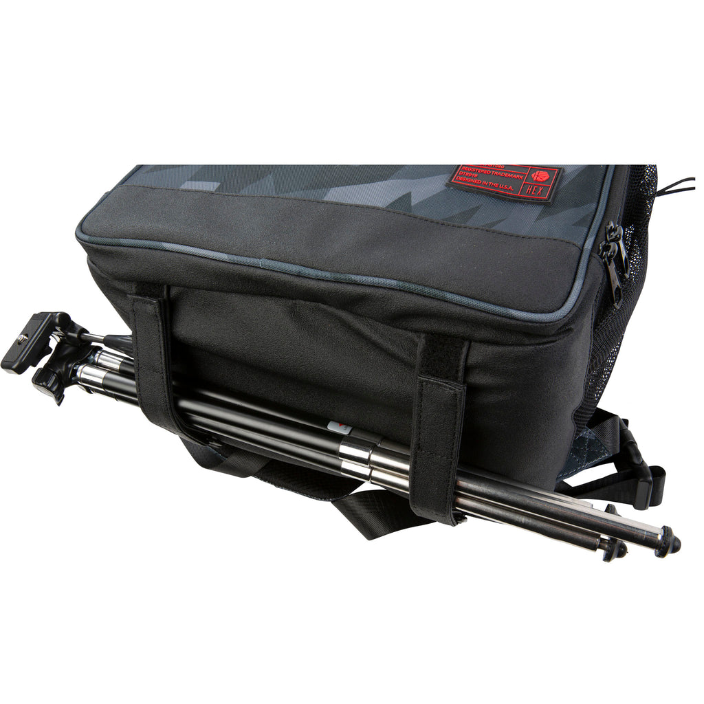 Glacier Cinema Backpack, Grey Camo. Bottom view showing a tripod being held by the tripod straps. 
