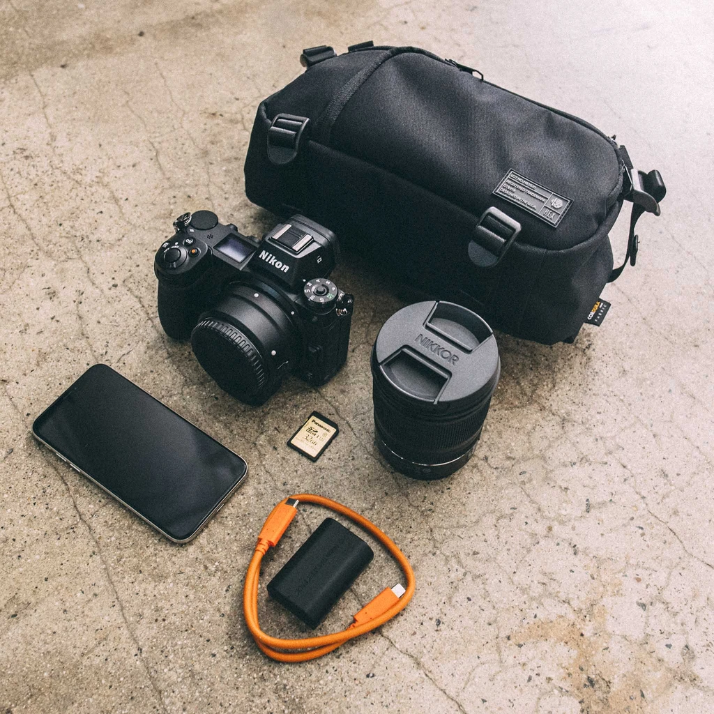 HEX Ranger DSLR Mini Sling, Black, laying flat with camera gear outside of bag