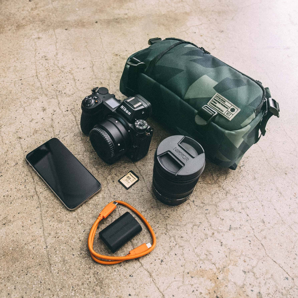 HEX Ranger DSLR Mini Sling, Camo, laying flat with camera gear outside of bag