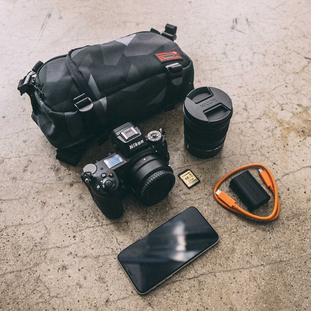 HEX Ranger DSLR Mini Sling, Glacier Camo, laying flat with camera gear outside of bag
