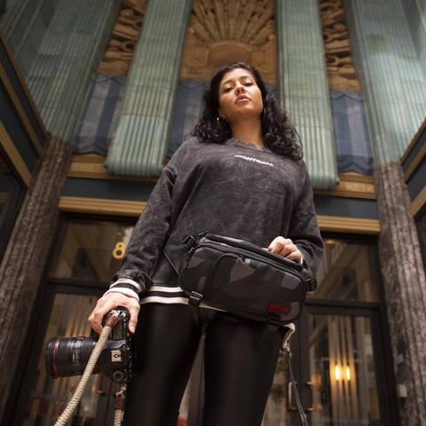 Woman wearing HEX Ranger Glacier Camo DSLR Mini Sling on front of body